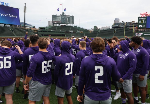 Northwestern players huddle before a game against Ohio State at Wrigley Field on Nov. 16, 2024, in Chicago. (John J. Kim/Chicago Tribune)