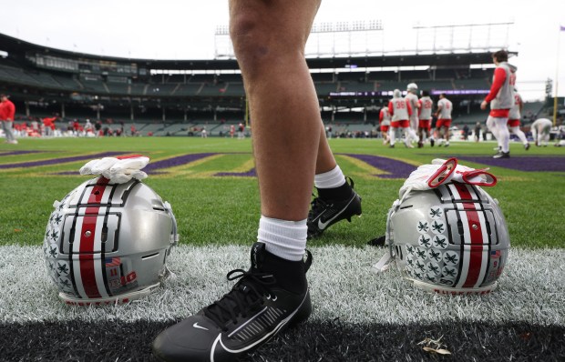 Ohio State wide receiver Brandon Inniss walks to his helmet after warming up for a game against Northwestern at Wrigley Field on Nov. 16, 2024, in Chicago. (John J. Kim/Chicago Tribune)