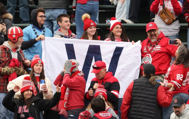 Ohio State fans hold a Chicago Cubs "W" flag after a 31-7 win over Northwestern at Wrigley Field on Nov. 16, 2024, in Chicago. (John J. Kim/Chicago Tribune)