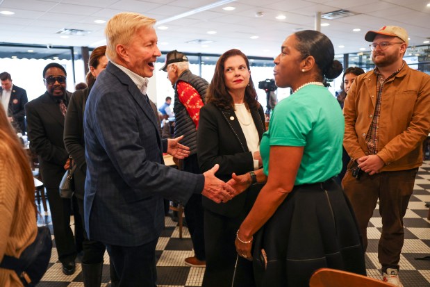 Cook County state's attorney Republican candidate Bob Fioretti, left, shakes hands with Lt. Gov. Juliana Stratton, right, while Democratic candidate Eileen O'Neill Burke stands nearby at Manny's Deli in the West Loop on Election Day, Nov. 5, 2024. (Eileen T. Meslar/Chicago Tribune)