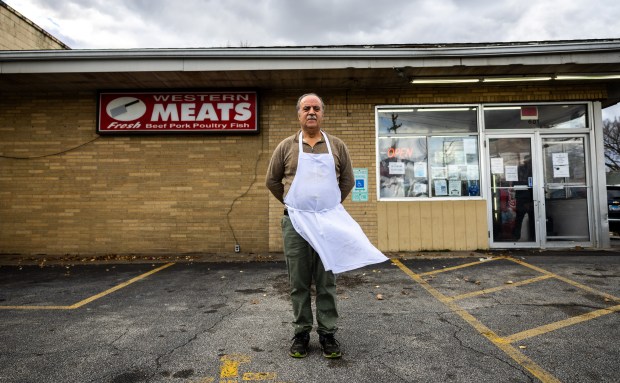 Albert Couri, owner of Western Meats, outside his shop in Peoria on Nov. 20, 2024. He came to Peoria from Aitou, Lebanon, in 1980 to be with family and to get away from the Lebanese civil war. "We don't want to die. We want to live in peace," he said. (Tess Crowley/Chicago Tribune)