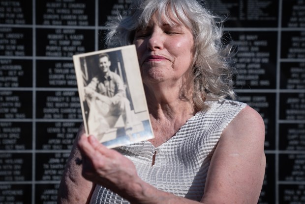 Carolyn Peckham remembers her late father, U.S. Marine Cpl. Delbert Tuttle, after receiving his Purple Heart medal from Illinois State Treasurer Michael Frerichs during a ceremony in Decatur on Oct. 29, 2024. (E. Jason Wambsgans/Chicago Tribune)