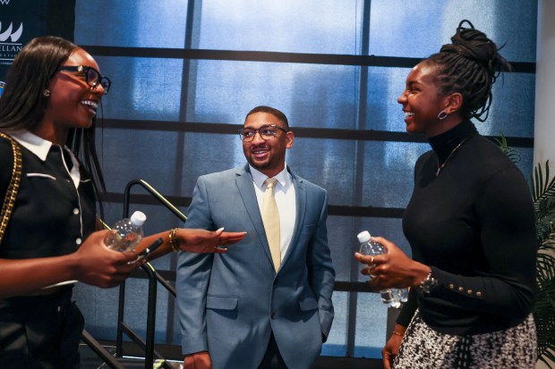 Chicago Sky players Michaela Onyenwere, left, and Elizabeth Williams, right, speak to new Sky head coach Tyler Marsh after a news conference at Wintrust Arena on Nov. 12, 2024. (Eileen T. Meslar/Chicago Tribune)