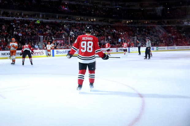 Blackhawks center Connor Bedard stands on the ice during a break in the action against the Ducks on Nov. 19, 2024, at the United Center. (Chris Sweda/Chicago Tribune)