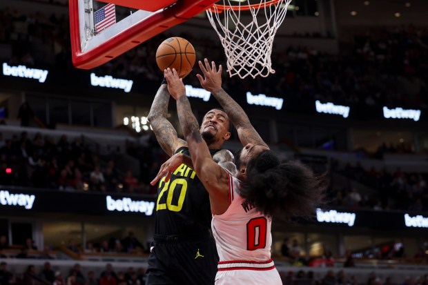 Utah Jazz forward John Collins (20) dunks on Chicago Bulls guard Coby White (0) during the second quarter at the United Center Monday Nov. 4, 2024, in Chicago. (Armando L. Sanchez/Chicago Tribune)