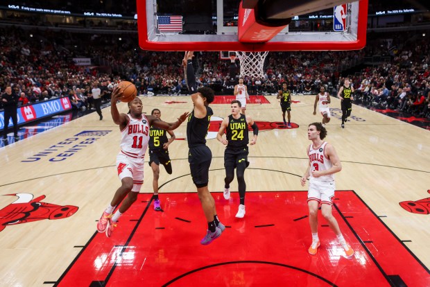 Chicago Bulls guard Ayo Dosunmu (11) goes up for a basket against Utah Jazz guard Keyonte George (3) during the first half at the United Center Monday Nov. 4, 2024, in Chicago. (Armando L. Sanchez/Chicago Tribune)