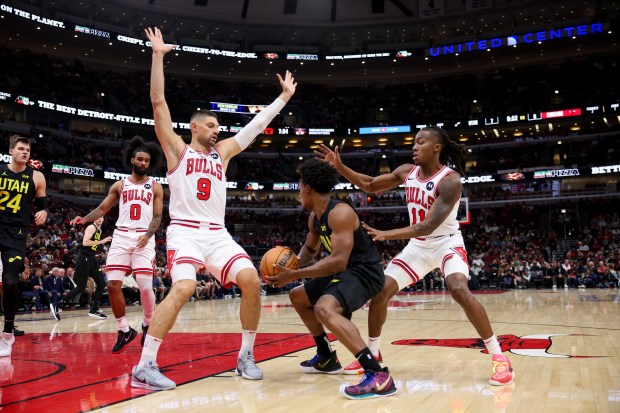 Chicago Bulls center Nikola Vucevic (9) and Chicago Bulls guard Ayo Dosunmu (11) guard Utah Jazz guard Collin Sexton (2) during the first quarter at the United Center Monday Nov. 4, 2024, in Chicago. (Armando L. Sanchez/Chicago Tribune)