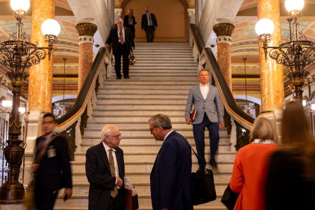 People talk in the halls on April 11, 2024, at the Illinois State Capitol in Springfield. (Brian Cassella/Chicago Tribune)