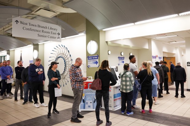 People wait in line to vote at the Goldblatt's Building in West Town on Oct. 28, 2024, during the early voting period. (Eileen T. Meslar/Chicago Tribune)