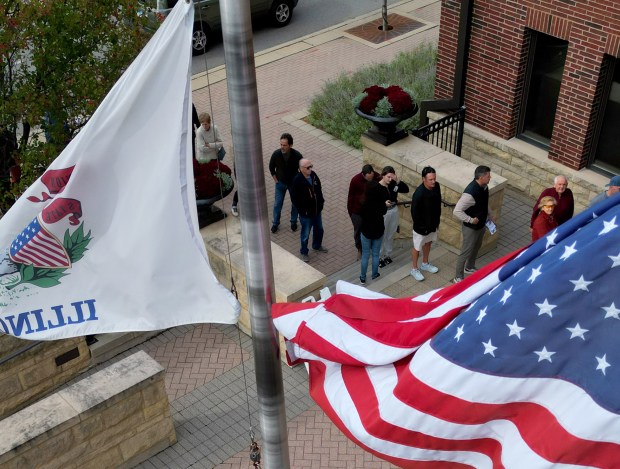 People line up outside the Arlington Heights Village Hall to vote early on Oct. 28, 2024. (Stacey Wescott/Chicago Tribune)