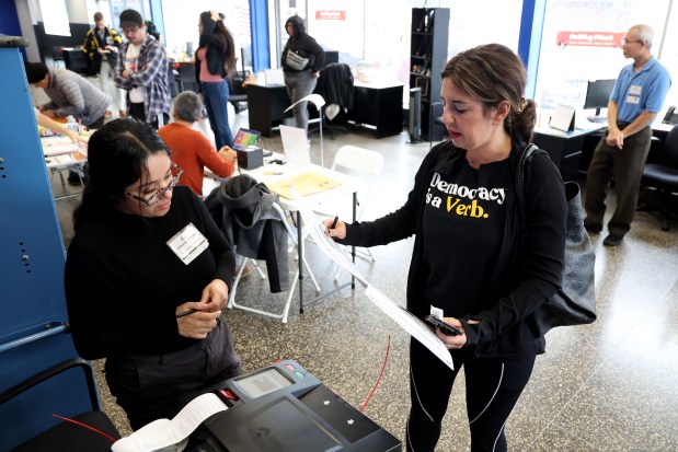 Maria Baltsas casts her ballot at the polling place inside Carfect on Nov. 5, 2024, in Chicago's Brighton Park neighborhood. (Antonio Perez/Chicago Tribune)