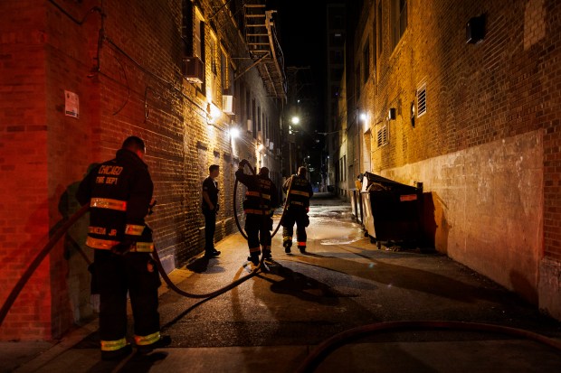 Chicago firefighters work in an alley where a man was fatally shot in the 900 block of West Eastwood Avenue in the Uptown neighborhood on Oct. 1, 2024. (Armando L. Sanchez/Chicago Tribune)