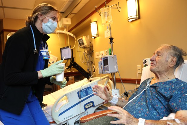 Registered nurse Regan Sauer talks with patient Oussama Bayazid at Elmhurst Hospital on Nov. 14, 2024. Endeavor Health Elmhurst Hospital has earned straight A's for patient safety from the nonprofit Leapfrog Group since 2012. (Antonio Perez/Chicago Tribune)