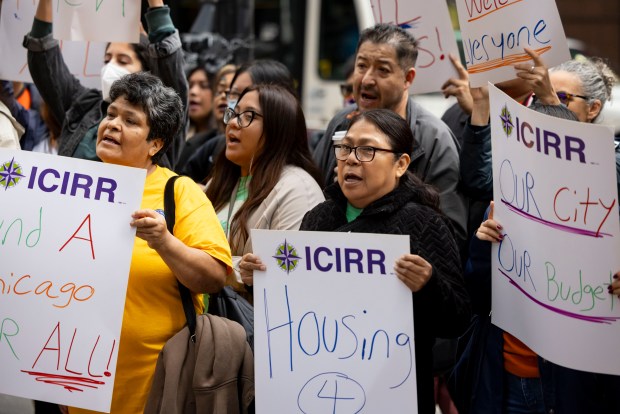 People rally outside City Hall on Oct. 31, 2024, as the Illinois Coalition for Immigrant and Refugee Rights raises concerns about the impact of upcoming shelter closures on migrant families and homeless people. (Brian Cassella/Chicago Tribune)