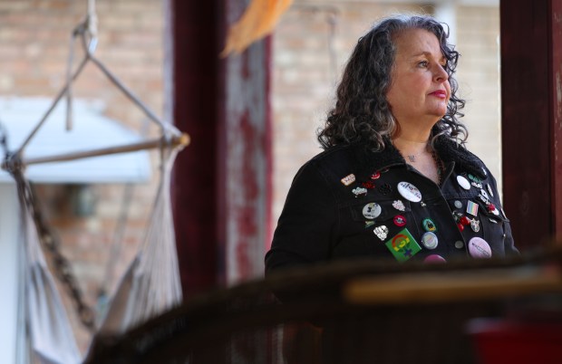 Marla Rose stands on her front porch in Berwyn on Nov. 12, 2024. Rose is considering pressing charges against Nick Fuentes following a pepper-spraying incident in front of Fuentes' home over the weekend. (Stacey Wescott/Chicago Tribune)