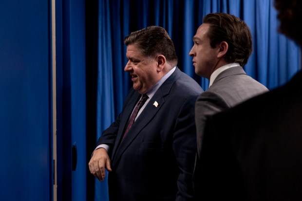 Gov. JB Pritzker, left, departs after speaking about the results of the election, on Nov. 7, 2024, at Illinois state government offices in Chicago. (Brian Cassella/Chicago Tribune)