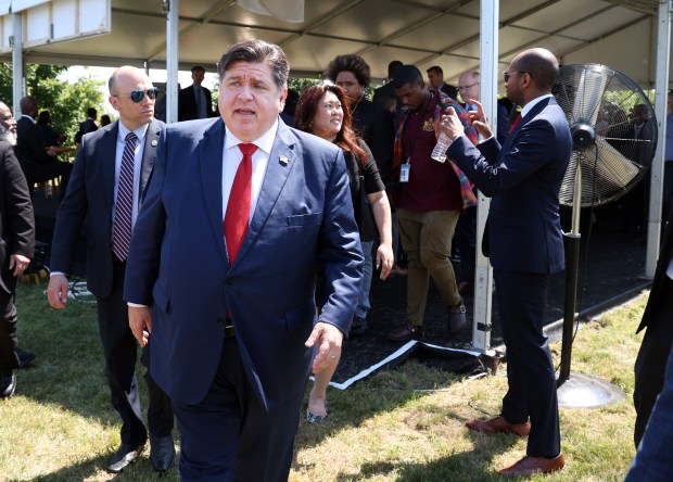 Illinois Gov. JB Pritzker, center, prepares to speak to reporters at a press conference on July 25, 2024, at the former U.S. Steel South Works site in Chicago where it was announced that the Illinois Quantum & Microelectronics Park will be built. (Terrence Antonio James/Chicago Tribune)