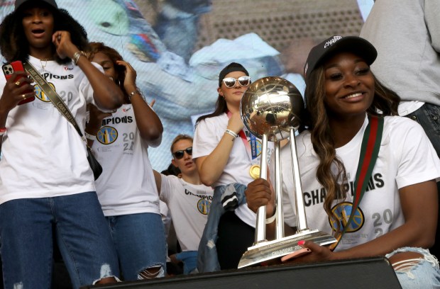 Chicago Sky player Dana Evans holds the trophy as the city of Chicago celebrates the 2021 WNBA Champion Chicago Sky, Tuesday, Oct. 19, 2021, during a rally at the Jay Pritzker Pavilion in Millennium Park. (Antonio Perez/ Chicago Tribune)