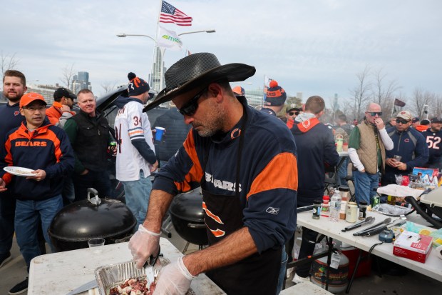 A fan (name withheld upon request) cooks octopus while tailgating before the Bears play the Green Bay Packers. (Armando L. Sanchez/Chicago Tribune)