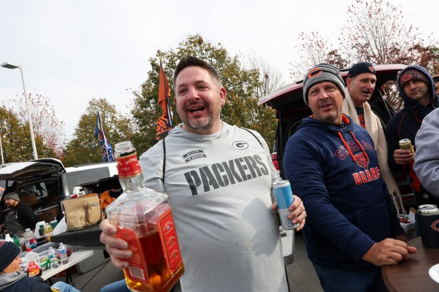 A fan drinks a bottle of liquor (name withheld upon) while tailgating before the Bears play the Green Bay Packers at Soldier Field. (Armando L. Sanchez/Chicago Tribune)