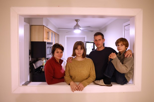 Veronika Markova and her husband, Vasily Bublikov, with their children, Sofiya, 15, and Eugene, 11, in their Rogers Park apartment on Nov. 20, 2024. Markova and Bublikov both have Russian and Ukrainian heritage. (Chris Sweda/Chicago Tribune)