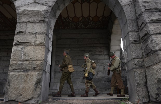 20th century military service reenactment members march into May Chapel for a Veterans Day observance and ceremony. (John J. Kim/Chicago Tribune)