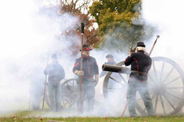 Cannon gun smoke surrounds members of the Chicago Light Artillery Battery A and B reenactment groups in a salute during a Veterans Day observance and ceremony at Rosehill Cemetery on Nov. 9, 2024. (John J. Kim/Chicago Tribune)