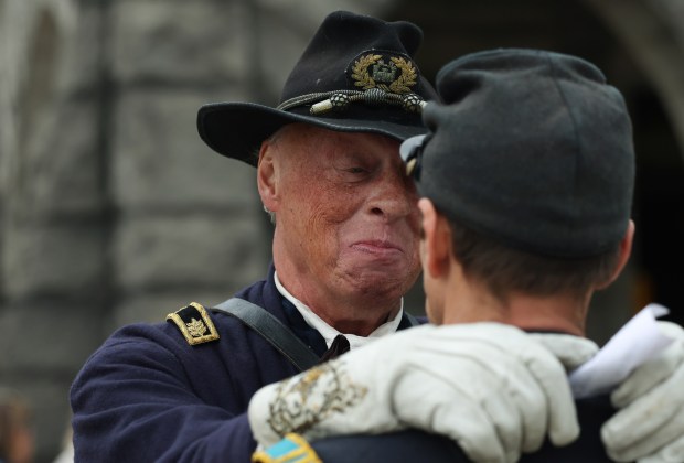 Mark Dembski greets a fellow Civil War reenactment service member at the conclusion of a Veterans Day observance and ceremony at Rosehill Cemetery on Nov. 9, 2024. (John J. Kim/Chicago Tribune)