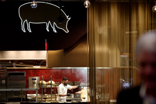 Chef Erik Keever prepares a roast pig Nov. 7, 2024, at the Southern District, one of the food stations at Wind Creek Chicago Southland casino. The casino planned practice sessions Thursday for regulators to assess readiness before issuing a license. (Antonio Perez/Chicago Tribune)