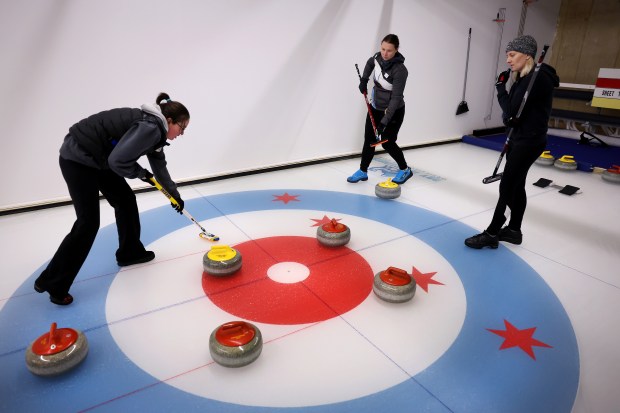 Merlin Howick, Anne Pettinger, and Tate Barry compete in a club league at Windy City Curling in Villa Park on Nov. 14, 2024. (Chris Sweda/Chicago Tribune)