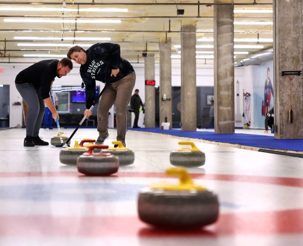 Adam Lubiak and Jason Koziol compete in a club league at Windy City Curling in Villa Park on Nov. 14, 2024. Chris Sweda/Chicago Tribune)