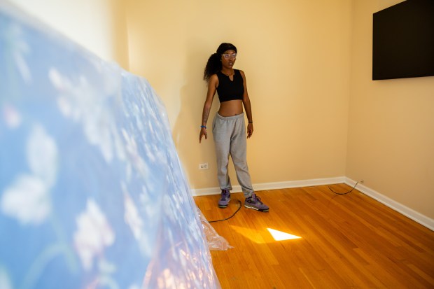 Bri Johnson, 20, stands in a bedroom while moving belongings into an apartment building in the Little Village neighborhood after moving out of a youth homeless shelter in Chicago's North Lawndale neighborhood earlier the same day on Sept. 15, 2024. (Tess Crowley/Chicago Tribune)