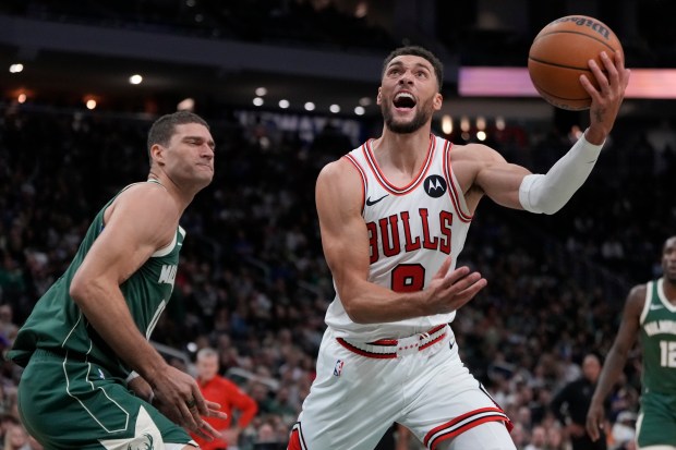 Bulls center Nikola Vučević shoots past the Bucks' Brook Lopez during the second half on Oct. 25, 2024, in Milwaukee. (Morry Gash/AP)