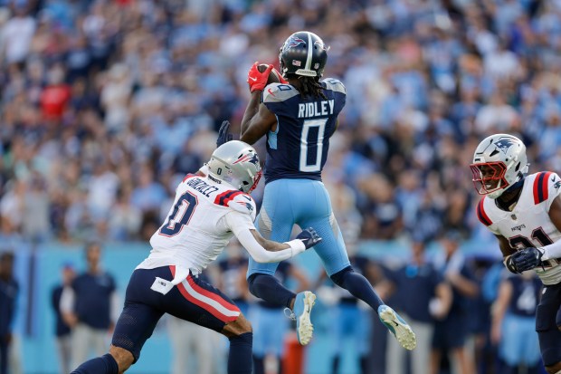 Titans wide receiver Calvin Ridley (0) catches a pass against Patriots cornerback Christian Gonzalez during overtime on Nov. 3, 2024, in Nashville, Tenn. (Stew Milne/AP)