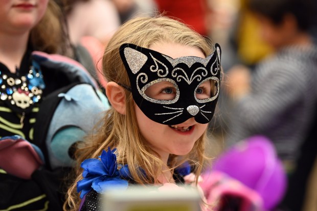 Shopping at vendors with family is Tiffany Schlobohm of Lake Villa, 7, a second-grader at the Village of Round Lake Beach Day of the Dead Celebration on Nov. 1, 2024 in Round Lake Beach. (Karie Angell Luc/Lake County News-Sun)