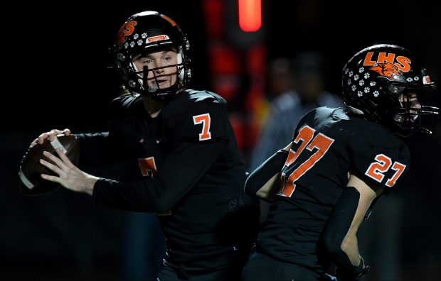 Libertyville's Steven Strelow (27) blocks as Libertyville's Quinn Schambow (7) drops back to throw a pass to Libertyville's Blaise LaVista (4) in the end zone. Libertyville defeated Deerfield 43-10 in their game in the first round of the Class 6A playoffs in Libertyville on Friday, Nov. 1, 2024 (Rob Dicker / for the News-Sun)