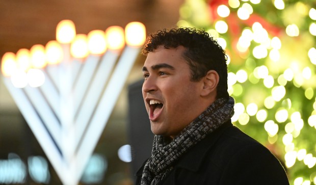 Singing as part of the Highland Park Players is soloist Elijah Warfield of Andersonville at the Holiday Lighting event at Port Clinton Square (600 Central Ave.) in downtown Highland Park on Nov. 23, 2024. (Karie Angell Luc/Lake County News-Sun)