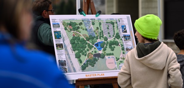 A youth looks at the master plan at the ribbon cutting ceremony at the renovated Jewett Park playground on Nov. 9, 2024 in Deerfield. (Karie Angell Luc/Lake County News Sun)