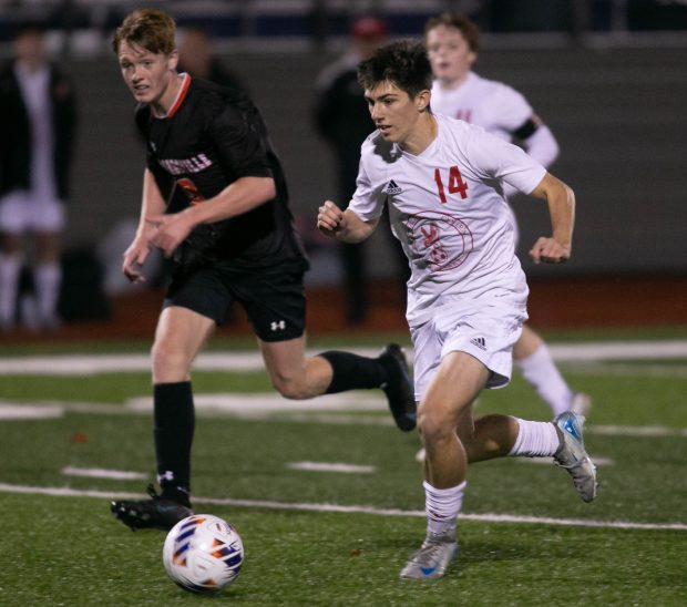 Naperville Central's Nolan Ewanic (14) moves the ball against Edwardsville during the Class 3A Normal Supersectional in Bloomington on Tuesday, Nov. 5, 2024. (Daryl Wilson / for the Naperville Sun)