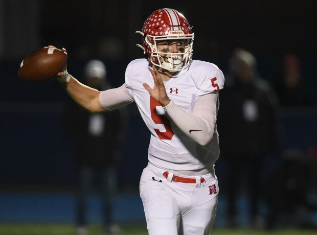 Naperville Central's Sebastian Hayes (5) rolls out to attempt a pass against Lyons Township during the Class 8A state quarterfinal Friday, Nov. 15, 2024 in Western Springs, IL. (Steve Johnston/for the Naperville Sun)