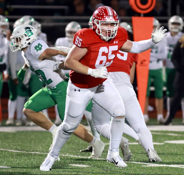 Naperville Central's William Erbeck blocks York during a play in the Class 8A state semifinal football game in Naperville on Saturday, Nov. 23, 2024. (James C. Svehla / Naperville Sun)