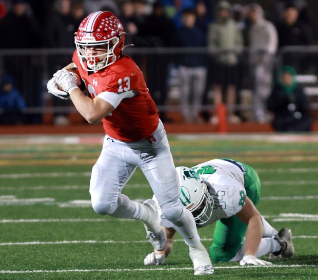 Naperville Central's Aiden Clark runs the ball past York during the Class 8A state semifinal football game in Naperville on Saturday, Nov. 23, 2024. (James C. Svehla / Naperville Sun)