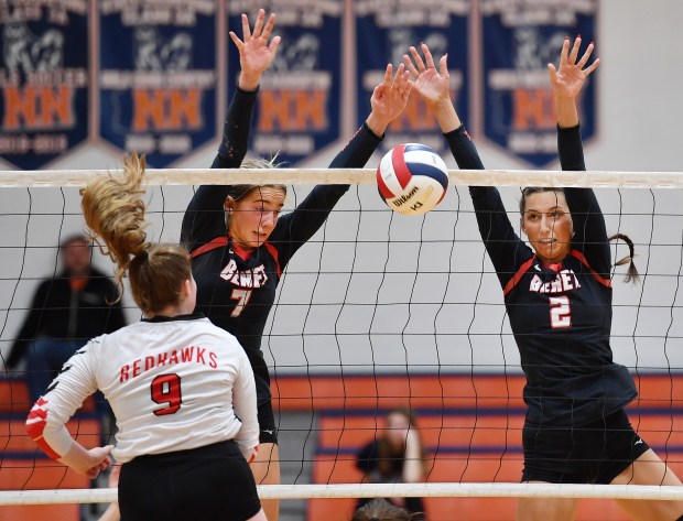 Benet's Audrey Asleson (7) and Gabriele Stasys (2) block a spike by Naperville Central's Caroline Impey (9) during the Class 4A Naperville North Regional championship match on Thursday, Oct. 31, 2024 in Naperville...(Jon Cunningham/for The Naperville Sun)