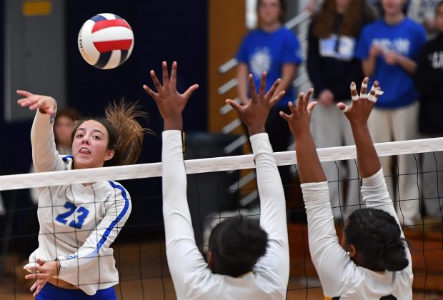 St. Charles North's Haley Burgdorf (23) spikes the ball past Metea Valley defenders Cheliyah Mattox (14) and Addison Torain during their match in the Class 4A West Aurora Sectional semifinals Tuesday, Nov. 5, 2024 in Aurora...(Jon Cunningham/for The Naperville Sun)