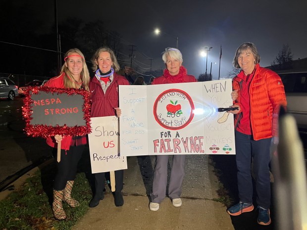 Brittney Samek, from left, Kris Blaida, Lisa Knox-Nervig and Margaret Mumford, classroom nurses who work for Naperville School District 203, were among those who attended a rally Monday night to draw attention to the fact that support staff members have been working without a contract since June. (Michelle Mullins/Naperville Sun)