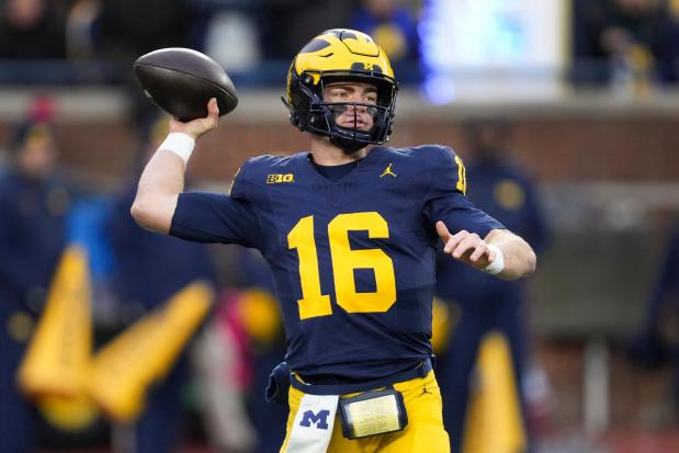 Michigan quarterback Davis Warren throws against Northwestern on Nov. 23, 2024, in Ann Arbor, Mich. (AP Photo/Paul Sancya)