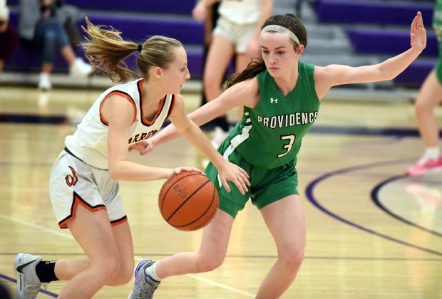 Lincoln-Way West's Peyton Madl (1) works against Providence's Molly Knight (3) during a WJOL Tournament second-round game at Joliet Junior College on Wednesday, Nov. 15, 2023.