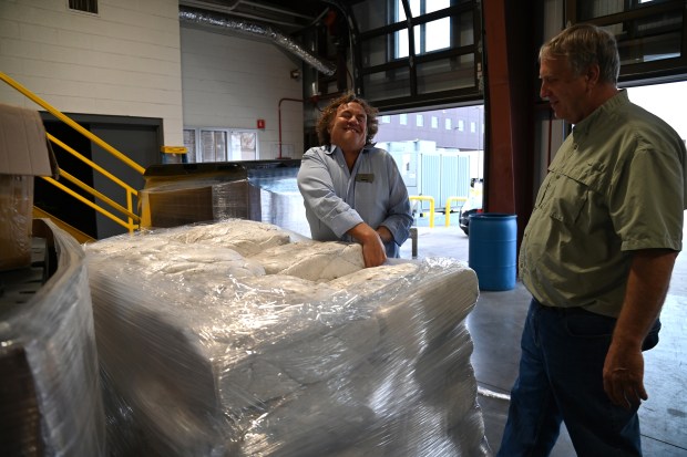 From left, in front of blocks of recycled styrofoam at Abt's recycling center are Mike Abt, formerly of Glencoe, also Abt co-president, with Brian Thomson, co-president of Honey Lake Bee Company of North Barrington, on Oct. 29, 2024. (Karie Angell Luc/Pioneer Press)