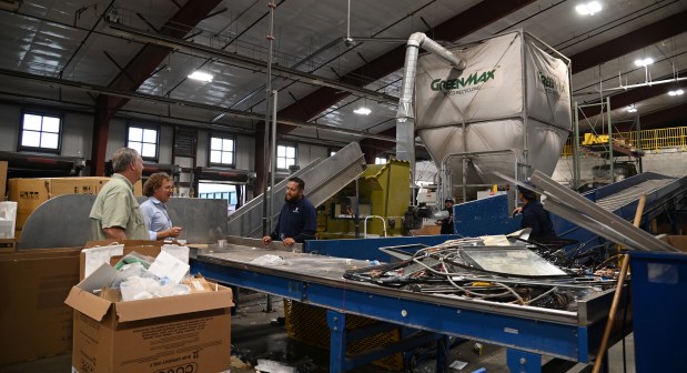 From left, in Abt's recycling center, are Brian Thomson of North Barrington, co-president of Honey Lake Bee Company of North Barrington, and Mike Abt, formerly of Glencoe and now of Chicago, in Glenview on Oct. 29, 2024. (Karie Angell Luc/Pioneer Press)