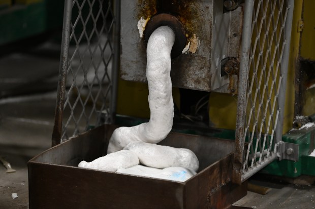 Heated recycled styrofoam oozes to fill a frame to cool in Abt's recycling center in Glenview on Oct. 29, 2024. (Karie Angell Luc/Pioneer Press)